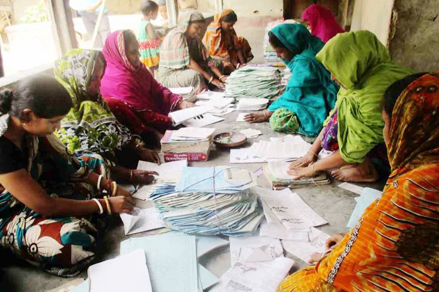 BOGRA: A group of female workers busy making paper packets in Muroil village under Kahaloo upazila.	— FE photo