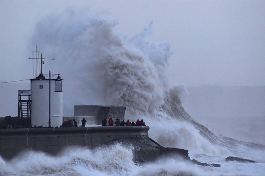 Waves hit the lighthouse and seawall at Porthcawl, in southern Wales, United Kingdom on Wednesday. (Reuters Photo)