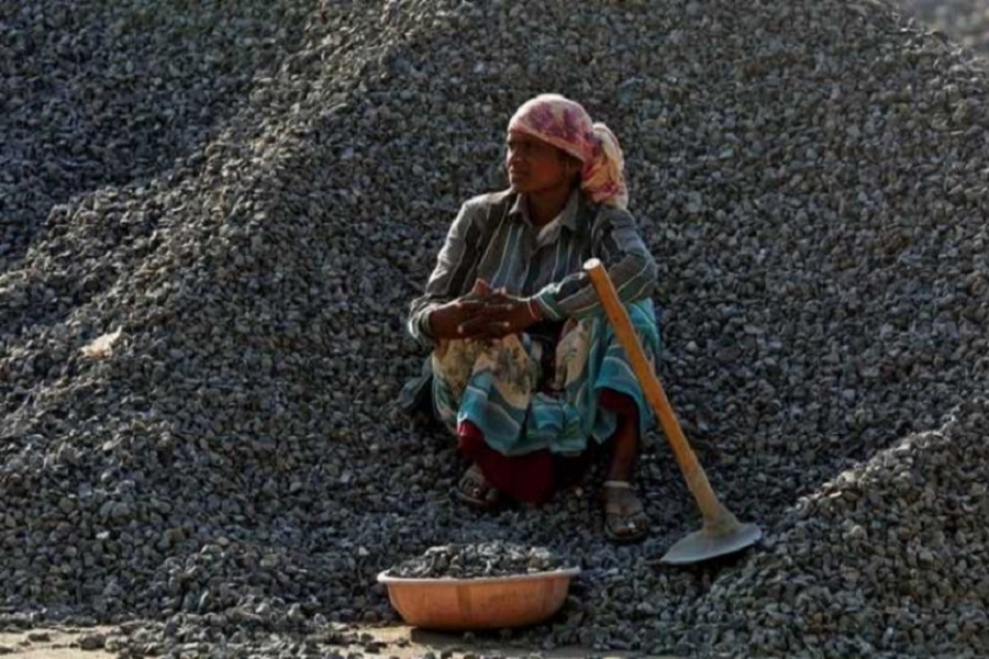 A woman labourer rests on a pile of stones at a construction site, in Mumbai, India March 16, 2017. Reuters/File Photo
