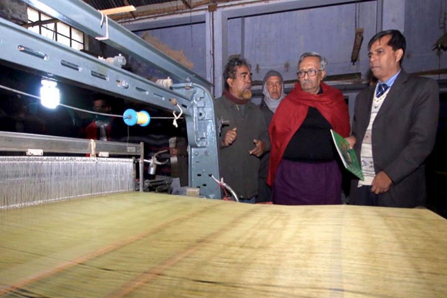Fazley Hossain Badsha (middle), Member of Parliament of Rajshahi Sadar constituency visits an unit of Rajshahi silk factory on Monday.	— FE photo