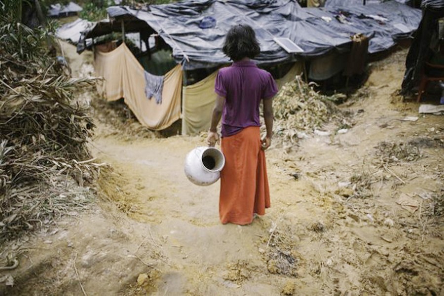A Rohingya girl goes out to fetch water in Balukhali camp, Bangladesh. 	— Umer Aiman Khan/IPS