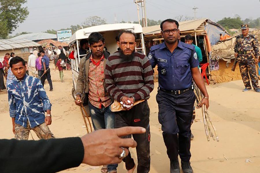 Police detain a Rohingya refugee over murder of another displace Myanmar national at Kutupalong camp in Cox's Bazar on Saturday. -Reuters Photo
