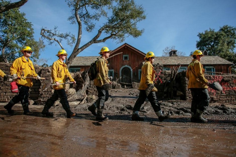 Rescue workers enter properties to look for missing persons after a mudslide in Montecito, California, US January 12, 2018. Reuters