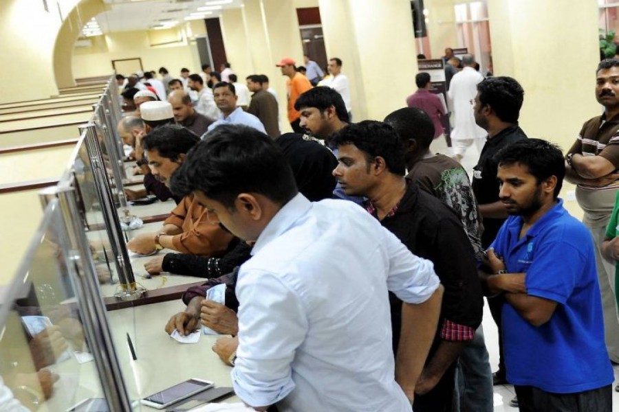 Expats in queue at an exchange house in Doha. - Peninsula Qatar