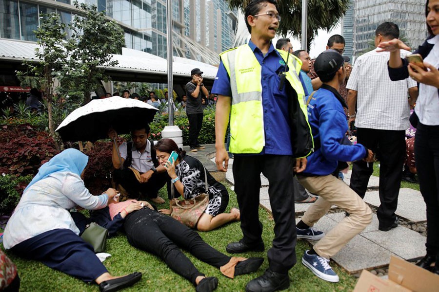 Injured people were seen outside the Jakarta stock exchange building (Reuters)