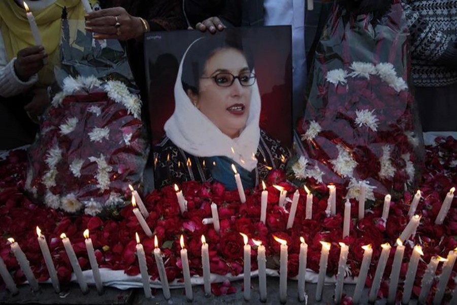 Supporters of Pakistan People's Party hold an image of Pakistan's former prime minister Benazir Bhutto during a candlelight vigil to commemorate her death anniversary in Lahore December 26, 2011. - Reuters file photo