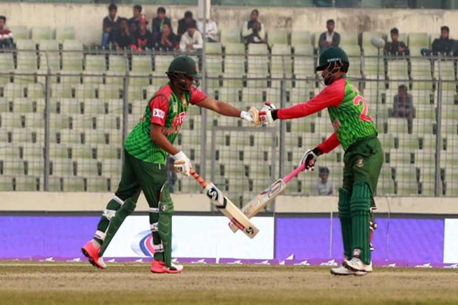 Allrounder Shakib Al Hasan and opener Tamim Iqbal celebrate after playing a shot  during the third one day international (ODI) cricket match in the Tri-Nation Series between Bangladesh and Sri Lanka