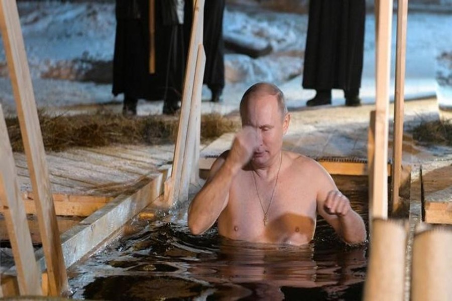 Russian President Vladimir Putin crosses himself as he takes a dip in the water during Orthodox Epiphany celebrations at lake Seliger, Tver region on Friday. - Reuters