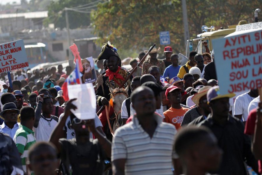 Protesters march during a protest against reported comments made by US President Donald Trump about Haiti, in the streets of Port-au-Prince, Haiti on Monday. - Reuters photo