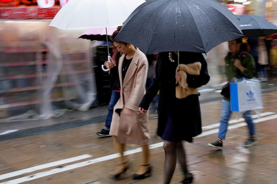 Shoppers walk through the rain in an Osaka shopping district in western Japan October 22, 2017. Reuters