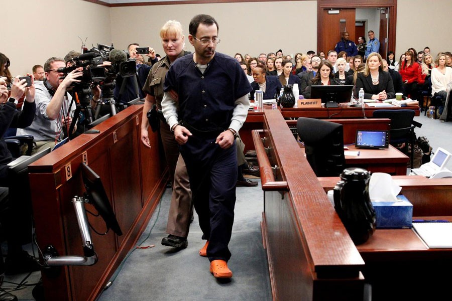 Larry Nassar, a former team USA Gymnastics doctor who pleaded guilty in November 2017 to sexual assault charges, is escorted into the courtroom during his sentencing hearing in Lansing, Michigan, US, January 24, 2018. (REUTERS)