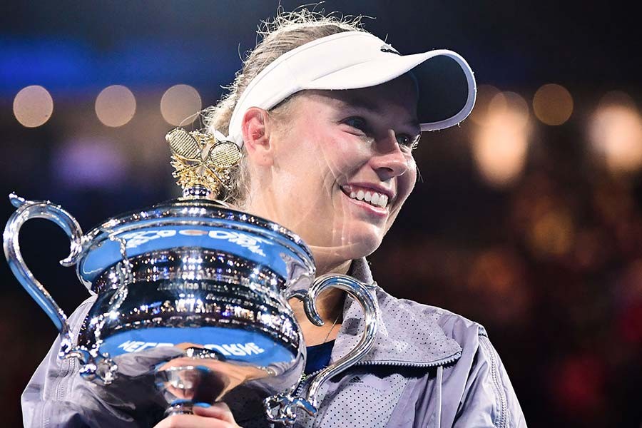 Wozniacki wins first Grand Slam, regains top ranking