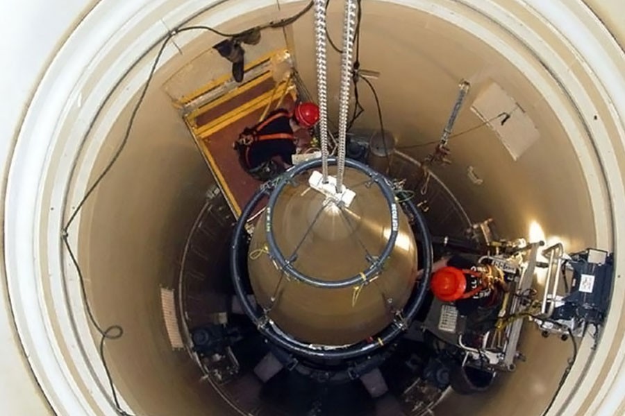 A US Air Force missile maintenance team removes the upper section of an intercontinental ballistic missile with a nuclear warhead in an undated USAF photo at Malmstrom Air Force Base, Montana. (REUTERS)