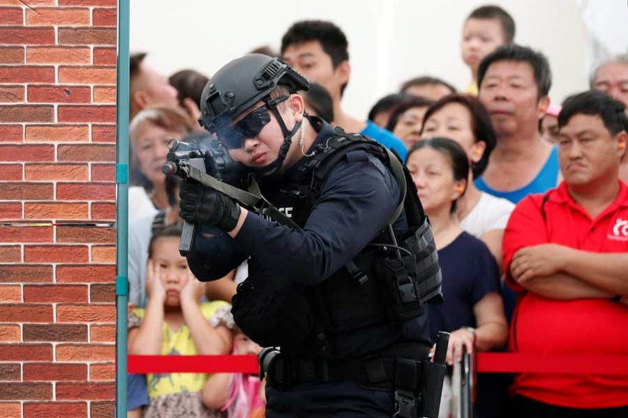 Police take part in a simulated gunmen attack demonstration for the public at a housing estate in Singapore December 10, 2017. Picture taken December 10, 2017. - Reuters