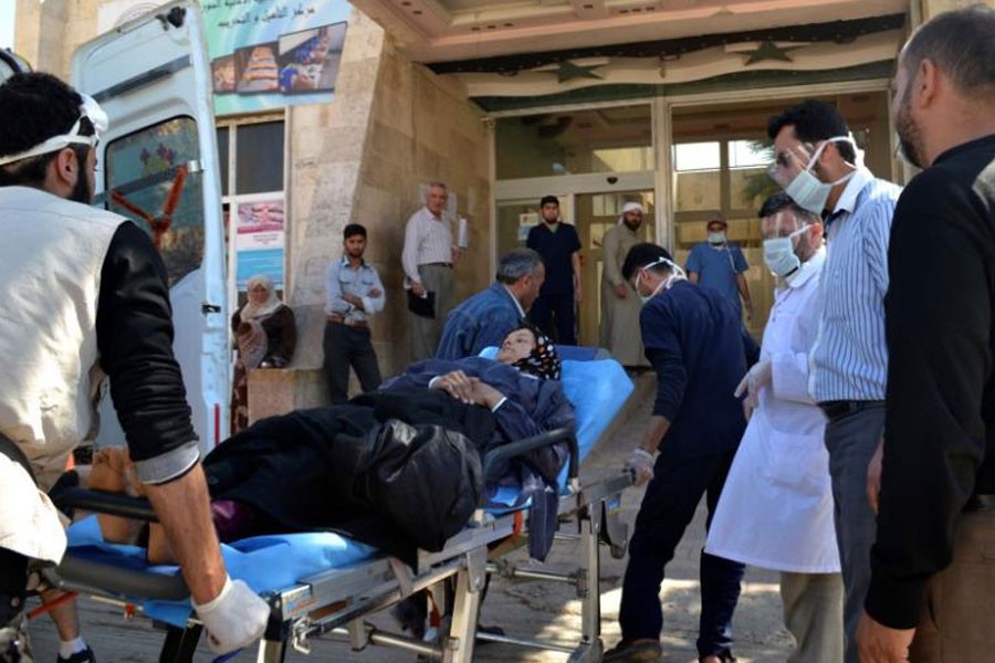 A woman affected by what activists say was a gas attack on the town of Telminnes is transferred to Bab al-Hawa hospital, which is close to the Turkish border, to receive treatment April 21, 2014. (REUTERS)