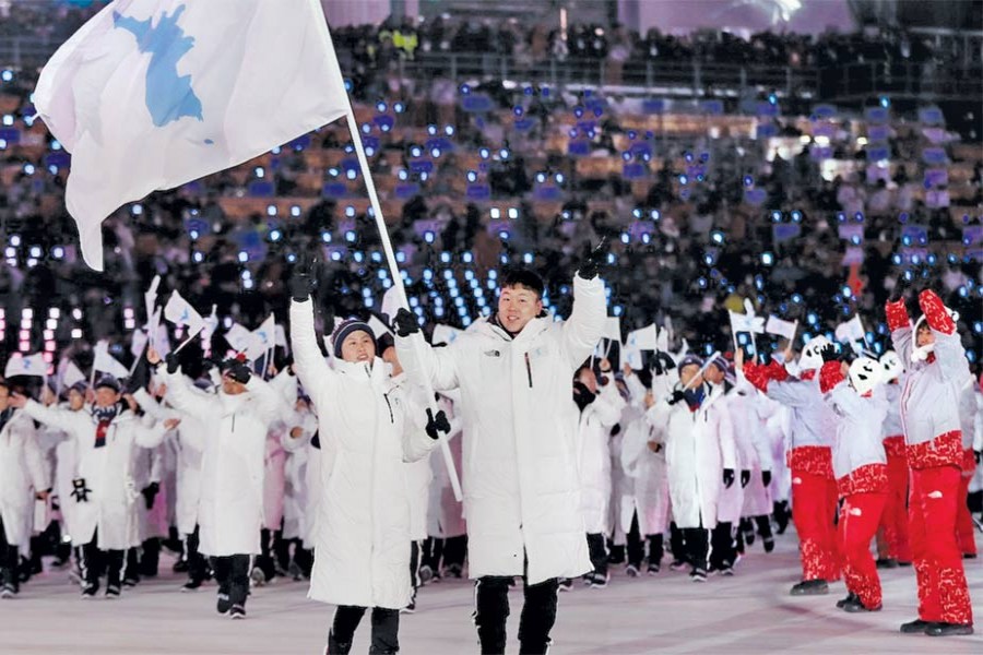 The North and South Korean Olympic delegations walked out together under a unified Korea flag during the Winter Olympics opening ceremony on February 09, 2018. 	—Photo: AP