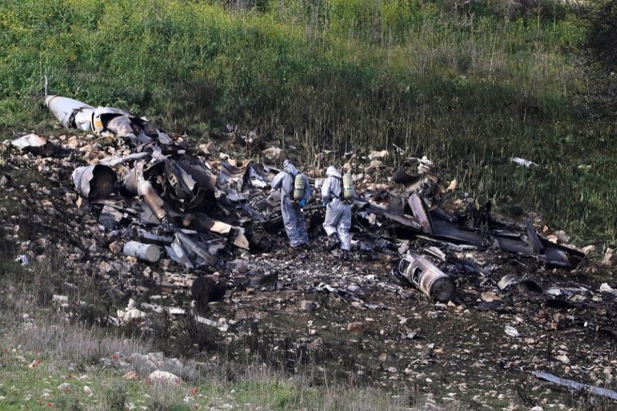 Israeli security forces examine the remains of an F-16 Israeli war plane near the Israeli village of Harduf, Israel February 10, 2018. Reuters