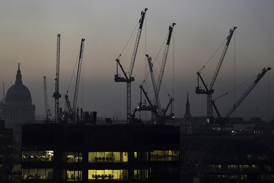 Offices are seen at dusk as St. Paul's cathedral and construction cranes are seen on the skyline in the London, Britain, on Nov 2, 2015. - Reuters file photo