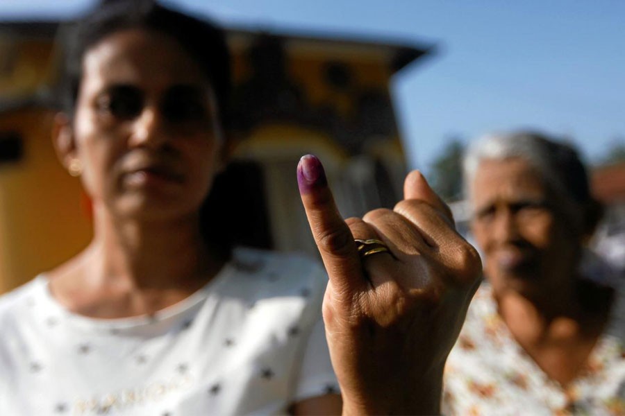 A woman shows her ink-stained finger after casting her vote at a polling station during the long-delayed local government elections in Colombo, Sri Lanka February 10, 2018. (REUTERS)