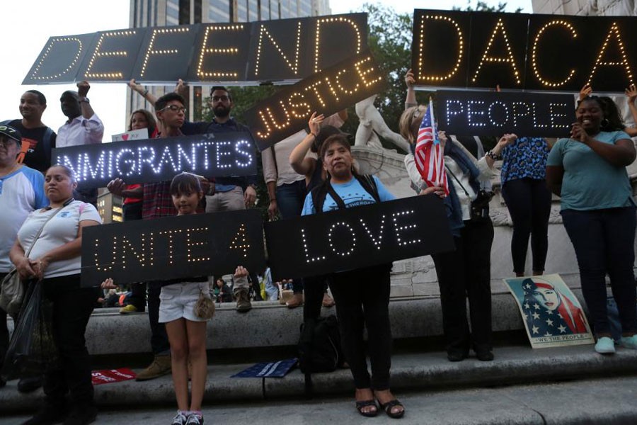 People hold signs against US President Donald Trump's proposed end of the DACA program that protects immigrant children from deportation at a protest in New York City, US, August 30, 2017. (REUTERS)