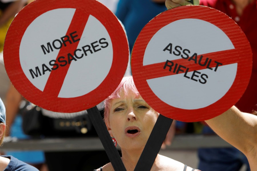 A protester is framed by signs calling for more gun control three days after the shooting at Marjory Stoneman Douglas High School, at a rally in Fort Lauderdale, Florida, US on Saturday. - Reuters photo