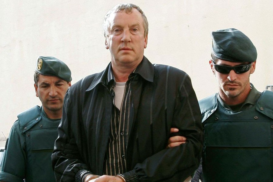 Police officers accompany Gennady Petrov, a mob boss linked to top Russian officials, after his arrest on the island of Mallorca in 2008. (Reuters)