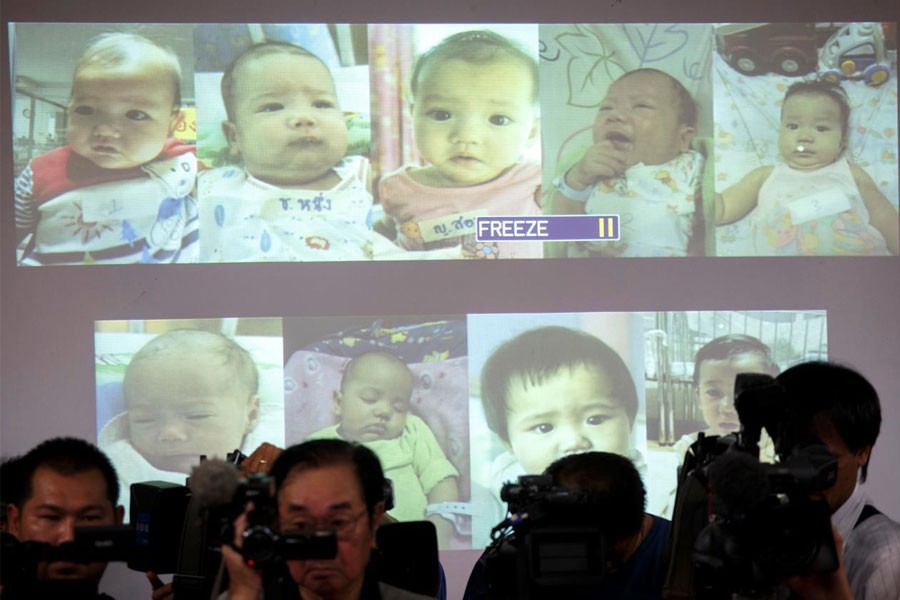 Surrogate babies that Thai police suspect were fathered by a Japanese businessman who has fled from Thailand are shown on a screen during a news conference. (Reuters file photo)