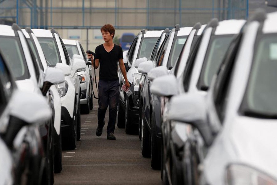 A worker checks cars made by GM Korea in a yard of GM Korea's Bupyeong plant, west of Seoul August 9, 2013. Reuters/File Photo