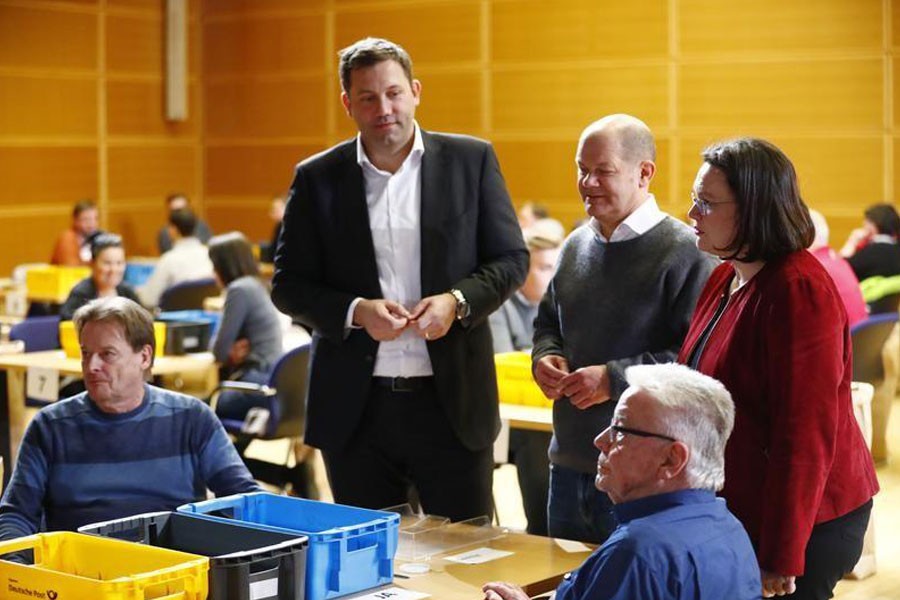 Andrea Nahles (R to L), Olaf Scholz and Lars Klingbeil of Social Democratic Party (SPD) look on as party members count ballot papers of the voting for a possible coalition, Berlin, Germany March 3, 2018. Reuters.