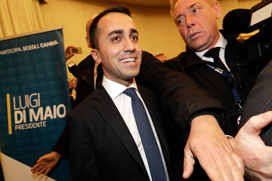 Five Star Movement's leader Luigi Di Maio smiles as he arrives for a press conference on the preliminary election results, in Rome, Monday, March 5, 2018. AP photo.