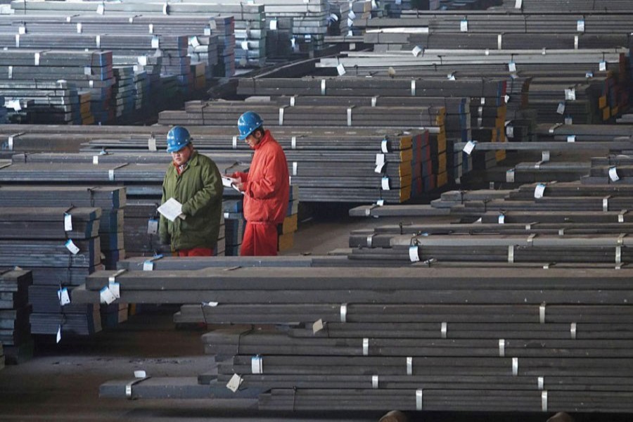 Workers check steel bars at a factory of Dongbei Special Steel Group Co., Ltd. in Dalian, Liaoning province, China November 27, 2017. Reuters/File Photo