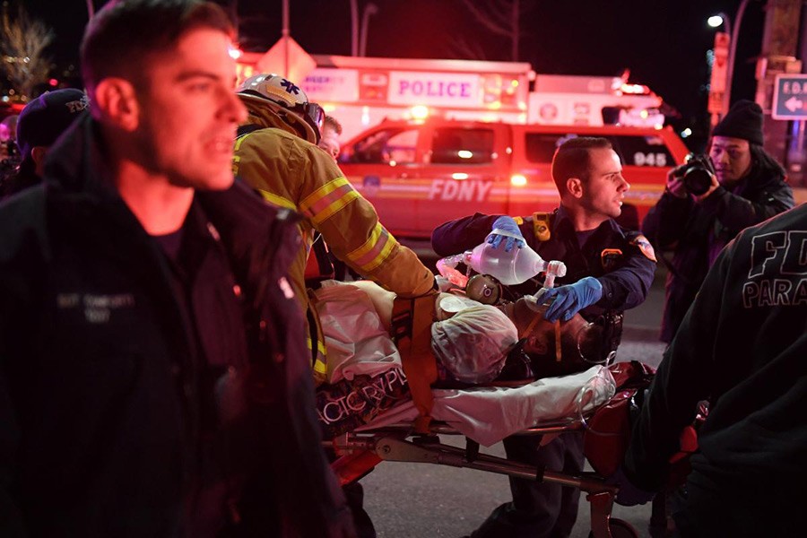 Paramedics and members of the NYFD seen performing CPR on a victim of a helicopter crash in New York, US on Sunday. The victim, however, later died in hospital. - Reuters photo