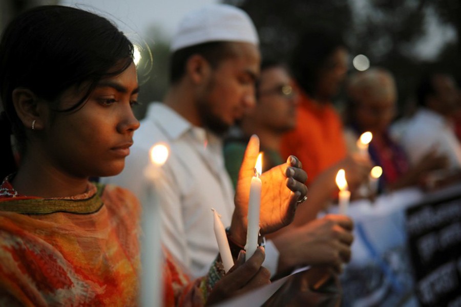 A candlelight vigil at the University of Dhaka in memory of those who died in the US-Bangla aircraft crash in Nepal recently. Reuters/Files