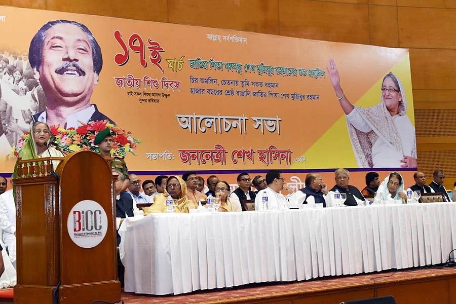 Prime Minister Sheikh Hasina addressing a discussion in Dhaka on Sunday marking the 98th birth anniversary of Father of Nation Bangabandhu Sheikh Mujibur Rahman. -Focus Bangla Photo