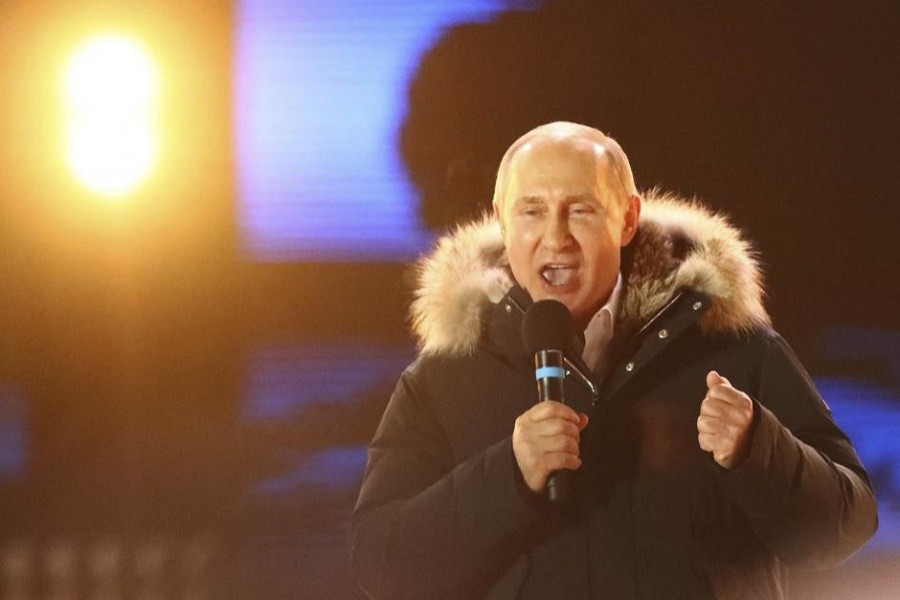 Russian President and Presidential candidate Vladimir Putin delivers a speech during a rally and concert marking the fourth anniversary of Russia's annexation of the Crimea region, at Manezhnaya Square in central Moscow, Russia March 18, 2018. Reuters