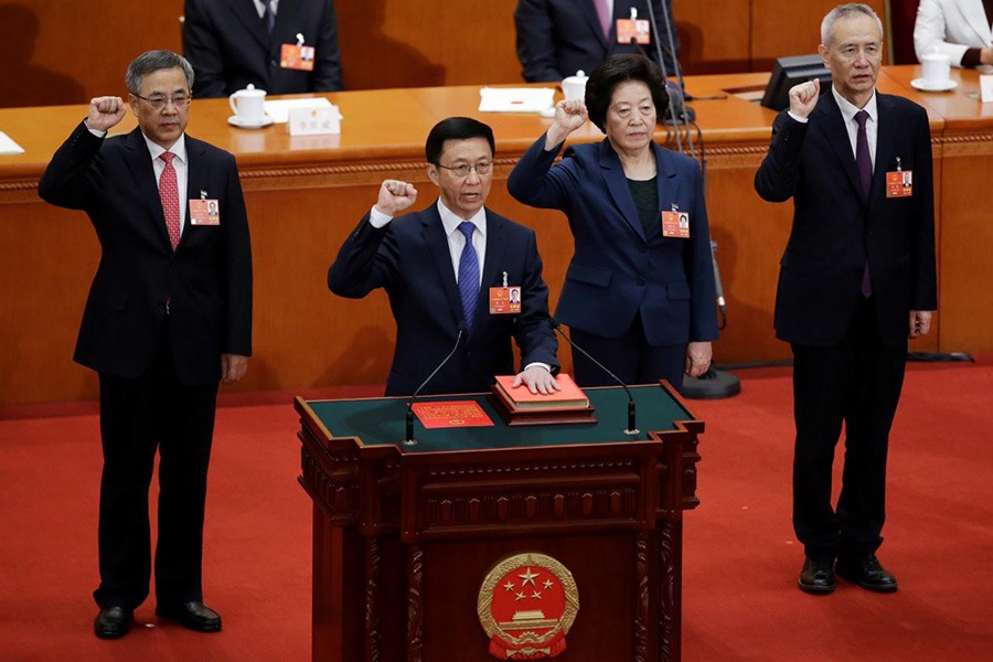 Newly elected Vice Premiers (L-R) Hu Chunhua, Han Zheng, Sun Chunlan, and Liu He take an oath to the constitution at the seventh plenary session of the National People's Congress (NPC) at the Great Hall of the People in Beijing, China on Monday - Reuters photo