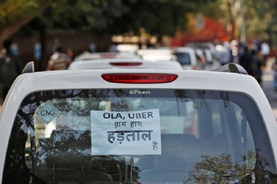 A note is pasted on a rear window of a car during a protest by Uber and Ola drivers, in New Delhi, India, February 14, 2017. The note reads “Ola and Uber it is Strike”. Reuters/Files