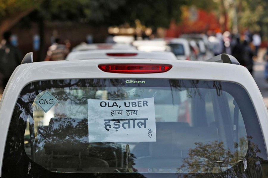 A note is pasted on a rear window of a car during a protest by Uber and Ola drivers, in New Delhi, India on February 14, 2017. The note reads “Ola and Uber it is Strike” - Reuters/File