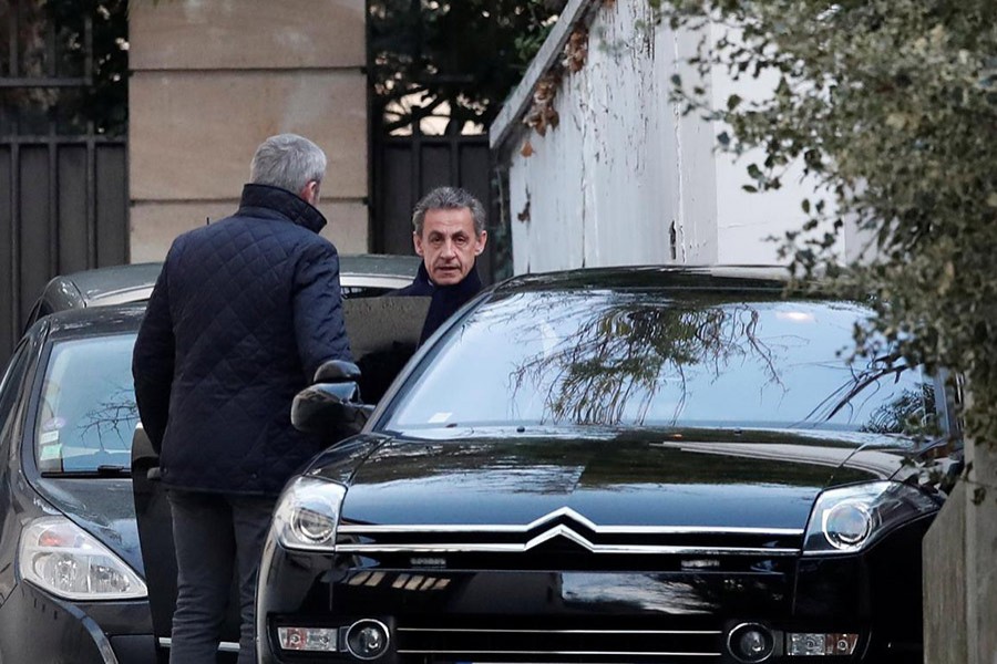 Former French President Nicolas Sarkozy enters his car as he leaves his house in Paris, France on Wednesday - Reuters photo