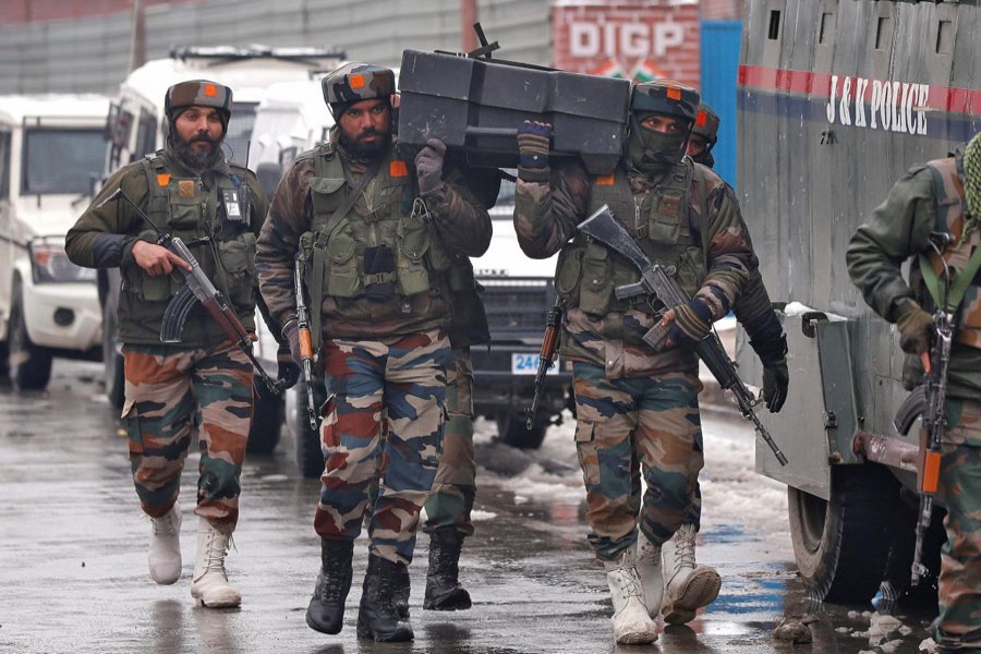 Indian army soldiers carry a box containing bulletproof shields near the site of a gunbattle with suspected militants in Srinagar February 12. Reuters/File Photo