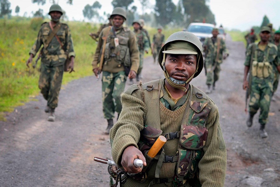 Congolese soldiers march through Kibumba after recapturing the town from M23 rebels - AP file photo