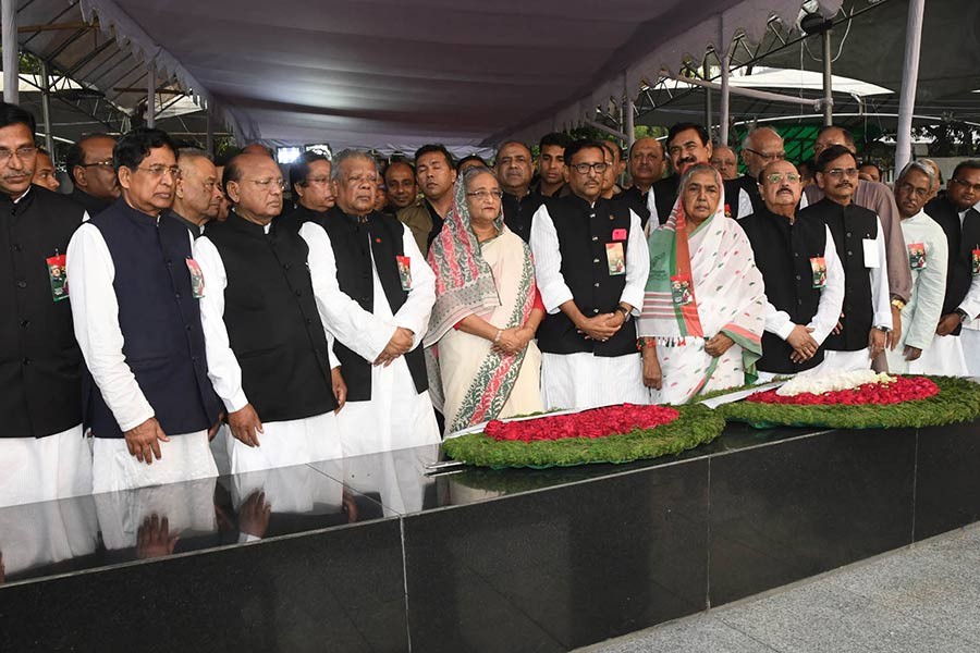 Prime Minister Sheikh Hasina is standing in solemn silence, flanked by central Awami League leaders, after placing wreath at portrait of Bangabandhu in front at Dhanmondi on Monday marking National Independence Day. -Focus Bangla Photo