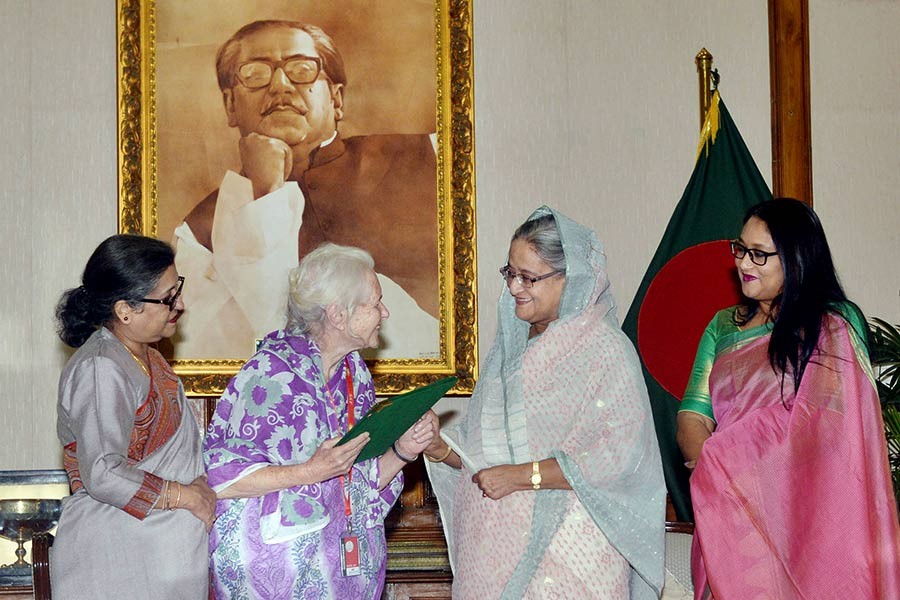 Prime Minister Sheikh Hasina handed over the citizenship certificate Lucy Helen Frances Holt at Ganobhaban on Saturday. -Focus Bangla Photo