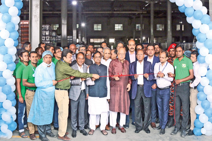 Finance Minister AMA Muhith cutting a ribbon in presence of ministers, parliament members, officials, industrialists and other dignitaries to open a celebration marking the inauguration of eight new industrial units of Meghna Group of Industries (MGI) at Meghnaghat in Narayanganj on Saturday