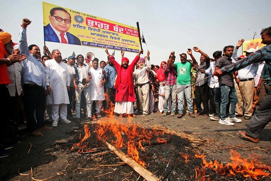 People belonging to the Dalit community shout slogans as they burn an effigy depicting India's Prime Minister Narendra Modi during a nationwide strike called by Dalit organisations, in Amritsar, India on Monday - Reuters photo