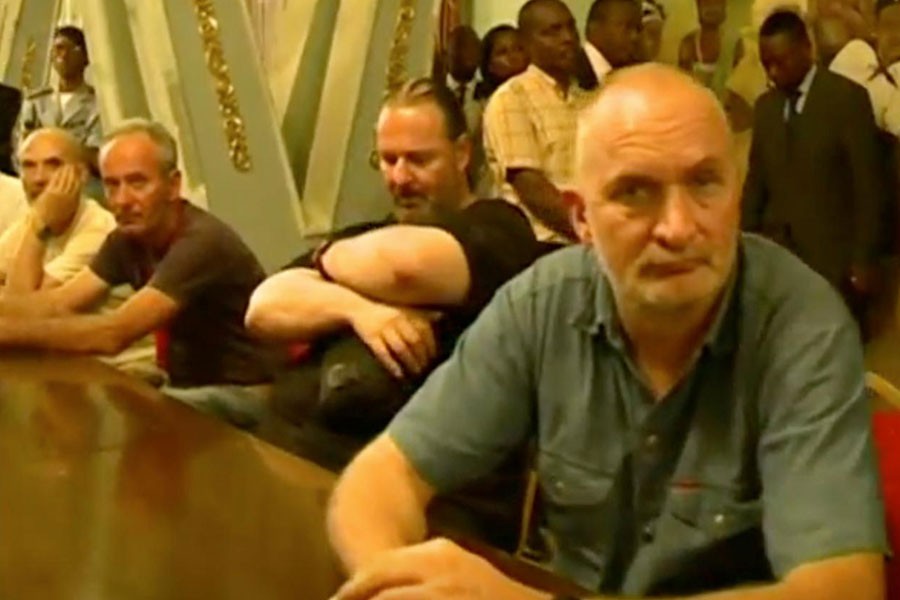 Tourists, who were held hostage, sit after they were freed in Yaounde, Cameroon April 3, 2018 in this picture taken from video. Reuters.
