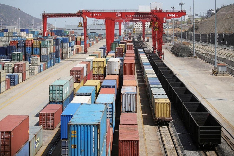 Shipping containers and train wagons are seen at a port in Lianyungang, Jiangsu province, China April 6, 2018. Reuters