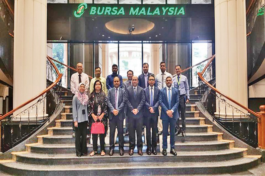 A team of Chittagong Stock Exchange (CSE) and CSE brokers pose for a photograph at the entrance of Bursa Malaysia, a Malaysian bourse, during their recent visit to Kuala Lumpur