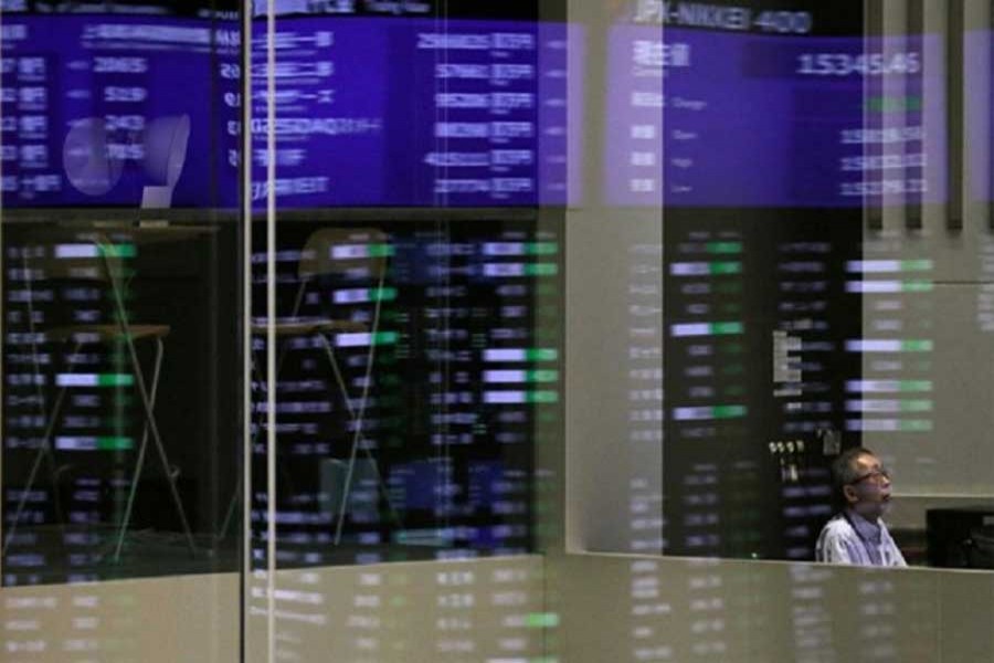 Market prices are reflected in a glass window at the Tokyo Stock Exchange (TSE) in Tokyo, Japan, February 6, 2018. Reuters/Files