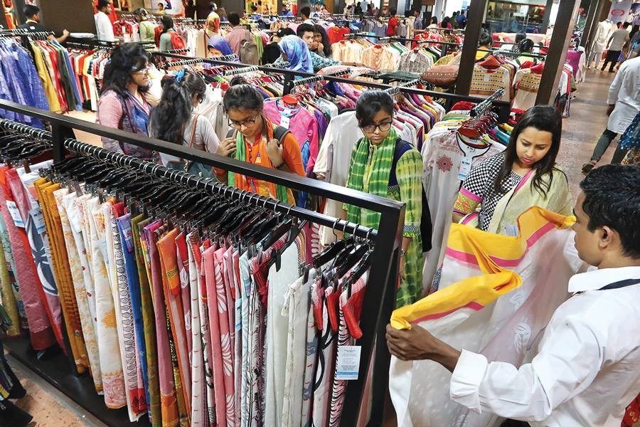 Representational image: Shoppers busy selecting sarees of their choice at a shop at Bashundhara City shopping mall on Friday for Pahela Baishakh, the first day of Bangla New Year recently. FE photo